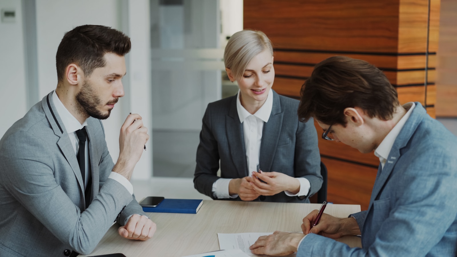 People reviewing insurance and legal documents at a table