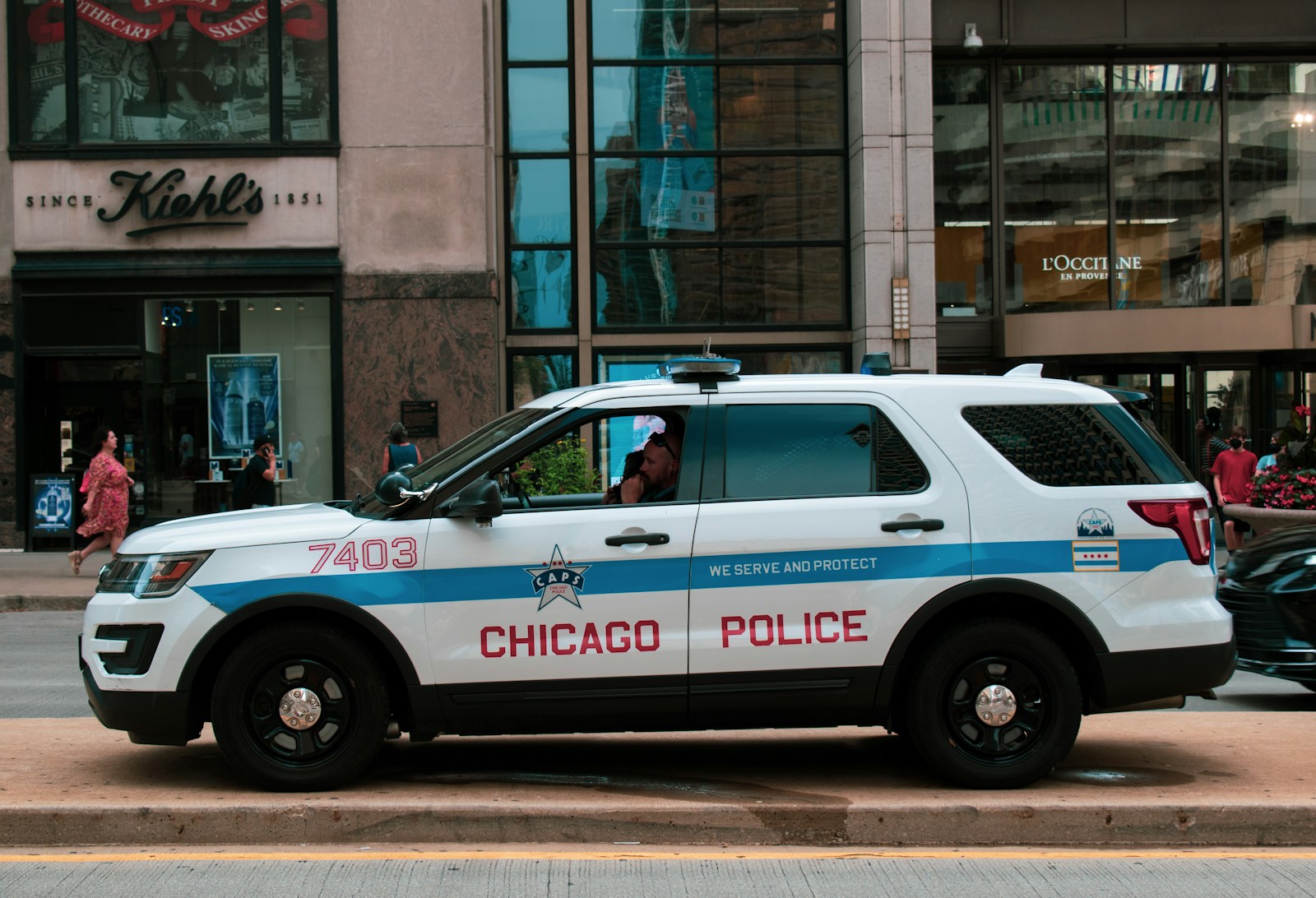Police vehicle parked on roadway shoulder at dusk