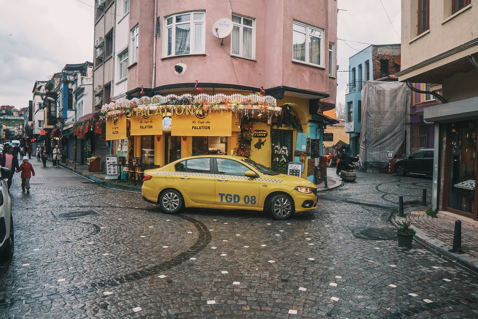 Yellow taxi driving through city traffic